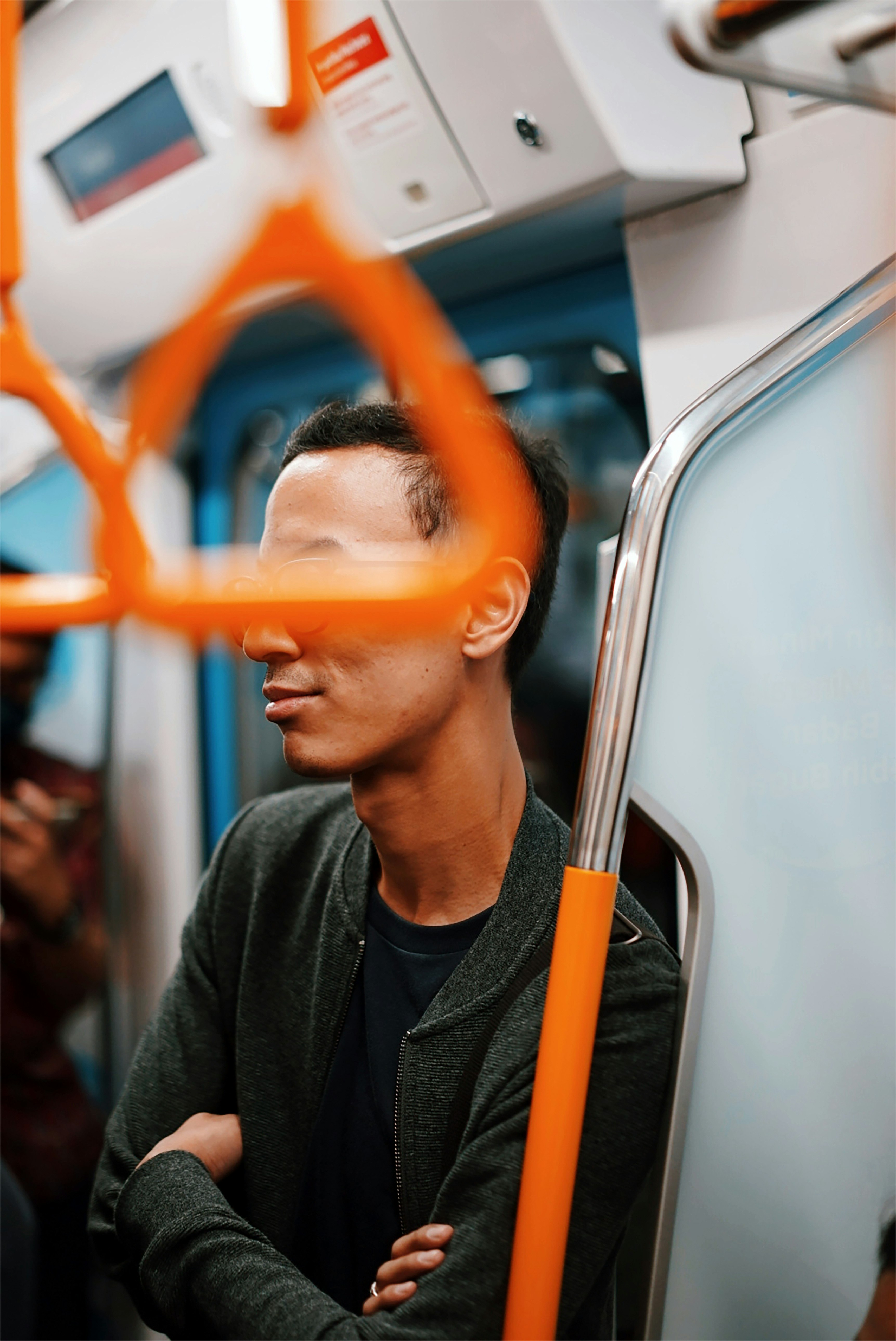 man in black jacket wearing orange framed eyeglasses